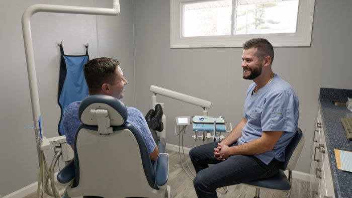 Dr. Bandy talking with a patient during a routine teeth cleaning | Bandy Dental in Holly, MI